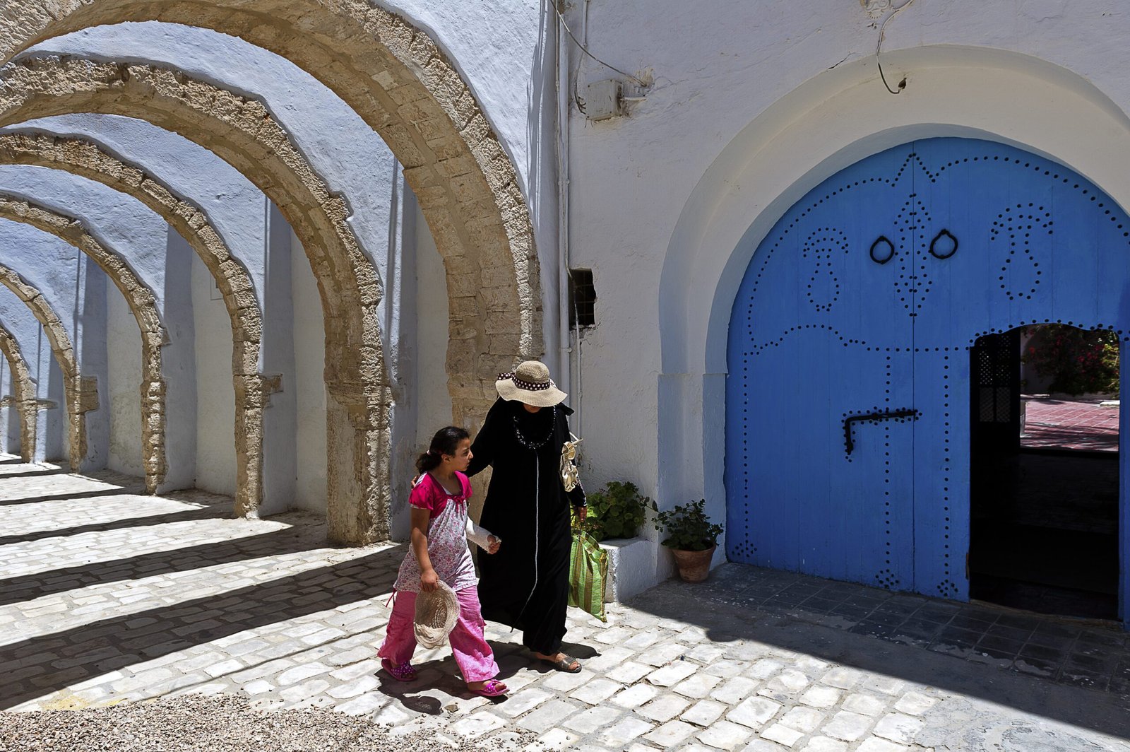 Arches and doors in Tunisia with two women walking